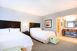 a hotel room with two beds and a piano at Hampton Inn & Suites Smithfield in Smithfield +13 photos