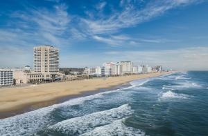 a view of a beach with buildings and the ocean at Hilton Virginia Beach Oceanfront in Virginia Beach
