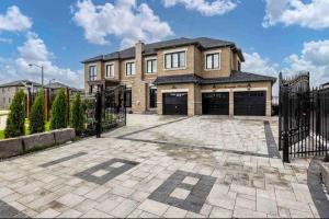 a large brick house with a large driveway at Newly build Estate home 40min from Airport in Stouffville