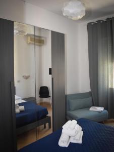 a hotel room with two beds and a mirror at Mau Beach House in Lido di Ostia