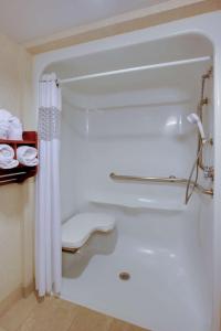 a bathroom with a bath tub with a shower curtain at Hampton Inn Richmond-West Innsbrook in Broad Meadows