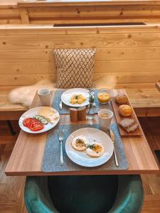 a table with plates of breakfast food on it at Dom Górski 878 mnpm in Zakopane