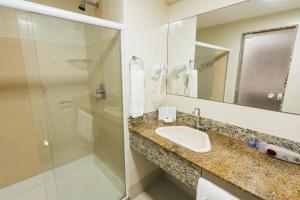 a bathroom with a sink and a shower at Resort Costa Dos Coqueiros in Imbassai +52 photos