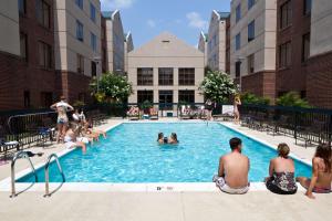 a group of people sitting in a swimming pool at Homewood Suites by Hilton Richmond - West End / Innsbrook in Broad Meadows