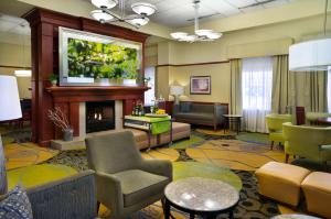 a lobby with a living room with a fireplace at Hilton Garden Inn Detroit Downtown in Detroit
