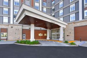 a large building with a parking lot in front of it at Hilton Garden Inn Fremont Milpitas in Fremont