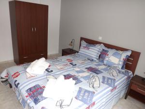 a bedroom with a bed with two lamps on it at Istira in Possidi