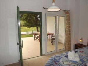 a bedroom with a sliding glass door leading to a patio at Istira in Possidi