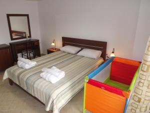 a bedroom with a bed with towels on it at Istira in Possidi