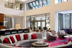 a living room with a large couch and red pillows at Hilton Woodland Hills/ Los Angeles in Woodland Hills