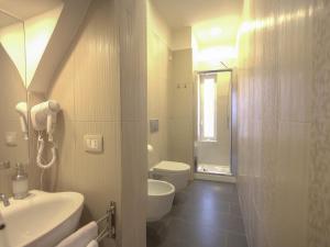 a bathroom with a sink and a toilet and a mirror at Altevolte Rooms in Catania +47 photos