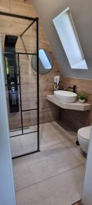 a bathroom with a glass shower and a sink at Joy resort Bran in Bran