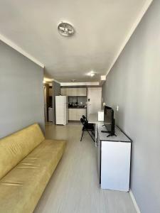 a living room with a couch and a television at Pasqualetto in Caxias do Sul