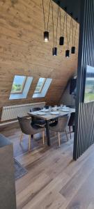 a dining room with a table and chairs and windows at Joy resort Bran in Bran +36 photos