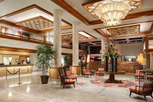 a lobby of a hotel with chairs and a table at Hilton Waikiki Beach in Honolulu