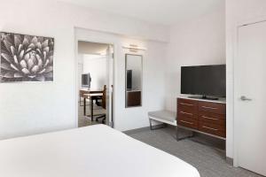 a hotel room with a bed and a flat screen tv at DoubleTree Suites by Hilton Phoenix in Phoenix