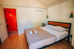 a bedroom with a bed and a red door at Brotseulebi in Ambrolauri