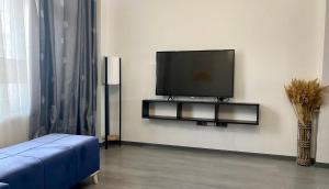 a living room with a flat screen tv on a wall at Newly Refurbished 2 Bedroom Apartment in the Heart of Istanbul in Istanbul