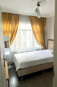 a bedroom with a bed and a large window at Newly Refurbished 2 Bedroom Apartment in the Heart of Istanbul in Istanbul