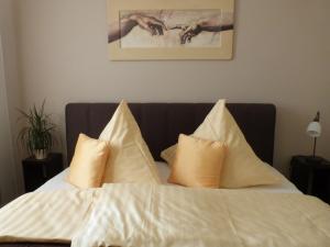 a bed with white sheets and pillows on it at Gästehaus Liubas Insel in Köthen