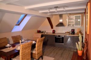 a kitchen and dining room with a table and chairs at Gästehaus Liubas Insel in Köthen