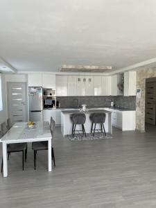 a kitchen with a table and two chairs in it at Pension Marko in Liptovský Mikuláš