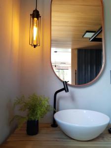 a bathroom with a white sink and a mirror at Vale Dos Pinheiros in Rio Forcação +76 photos