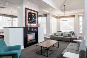 a living room with a couch and a fireplace at Hilton Garden Inn DFW North Grapevine in Grapevine