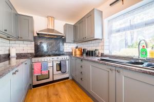 a kitchen with white appliances and a window at The Decker Apartment in Looe