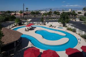 an overhead view of a swimming pool with red umbrellas at Hilton Garden Inn Tucson Airport in Tucson