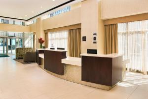a lobby with two reception desks and windows at Homewood Suites Dallas Downtown in Dallas