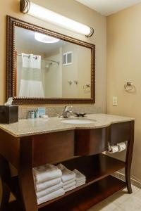 a bathroom with a sink and a large mirror at Hampton Inn Bennington in Bennington