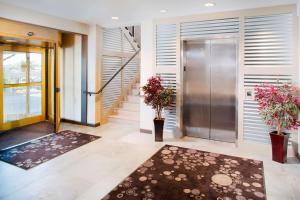 a hallway with a door and a lobby with plants at Hilton Garden Inn Providence in Providence