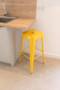 a yellow stool sitting next to a kitchen counter at Agroturismo Montefrío in Urnieta