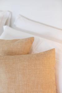 a close up of a pillow on a bed at Agroturismo Montefrío in Urnieta