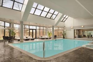 a large swimming pool with a large skylight at Hilton East Brunswick in East Brunswick