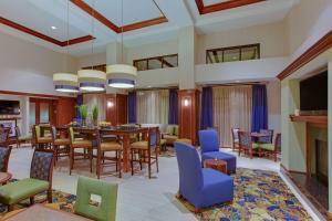 a dining room with a table and chairs at Hampton Inn and Suites Fredericksburg South in Fredericksburg