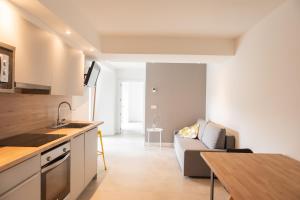 a kitchen and living room with a couch and a table at Agroturismo Montefrío in Urnieta