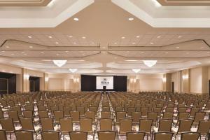 a large room with chairs and a screen at Hilton East Brunswick in East Brunswick