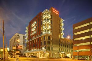 a tall building with a sign on top of it at Hampton Inn and Suites Austin University Capitol in Austin