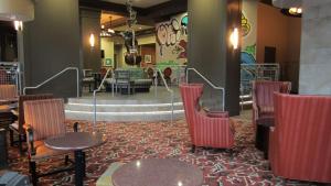 a restaurant with chairs and tables and a staircase at Hampton Inn and Suites Austin University Capitol in Austin