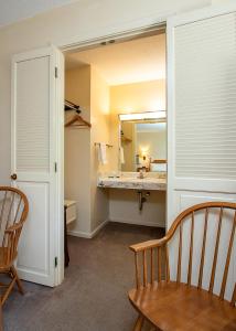 a bathroom with a sink and a mirror at Country Squire inn and suites in Coshocton