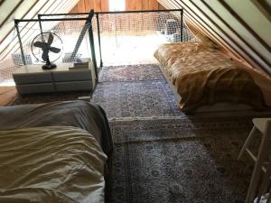 a bedroom with two beds in a tent at Mamas Cabin in Laag-Soeren