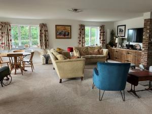a living room with a couch and a table at Withy Farm in Canterbury