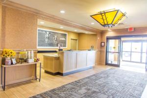 a hotel lobby with a reception desk and a yellow light at Hampton Inn & Suites Dodge City in Dodge City