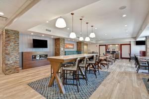 a dining room with tables and chairs and a fireplace at Hampton Inn Moab in Moab