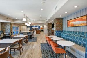a dining room with tables and chairs at Hampton Inn Moab in Moab