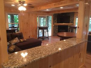 a kitchen and living room with a couch and a fireplace at KastleRock of the Highlands in Banner Elk