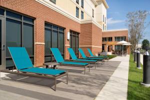 a row of lounge chairs outside of a building at Homewood Suites By Hilton Southaven in Southaven