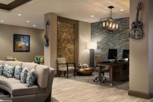 a living room with a couch and a desk at Homewood Suites By Hilton Memphis - Southaven in Southaven